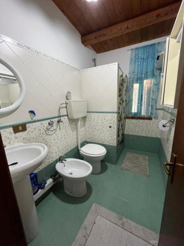 a bathroom with two toilets and a sink at B&b Salvatore in Balestrate