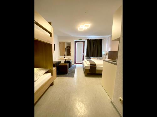 a hotel room with a bed and a living room at Hana Aparthotel in Hamburg