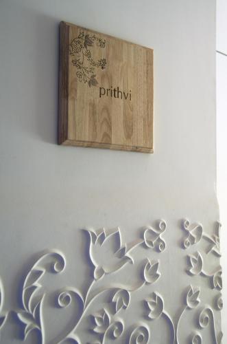 a wooden sign on a wall with a painting on it at President - IHCL SeleQtions in Mumbai