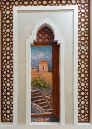 a painting of a door with a painting of a building at Durrat Nizwa Inn in Nizwa