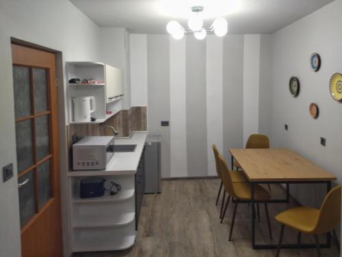 a kitchen and dining room with a table and chairs at Altavista mountain apartment in Samokov