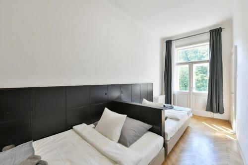 a living room with a couch and a window at WSP Petrin Garden Apartments in Prague