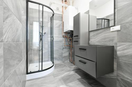 a bathroom with a shower and a sink at WSP Petrin Garden Apartments in Prague