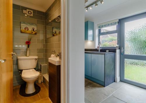 a bathroom with a toilet and a sink at Rushmere in Reydon