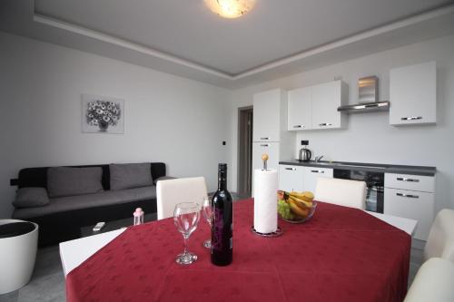 a dining room table with wine bottles and glasses on it at Apartments Toni in Primošten