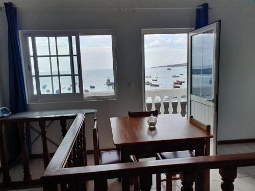 a dining room with a table and a view of the ocean at Seaview Apartment in Tarrafal