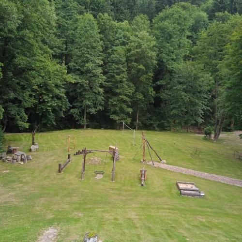 an empty park with a playground and swings at apartmány pod Vysákem in Stárkov