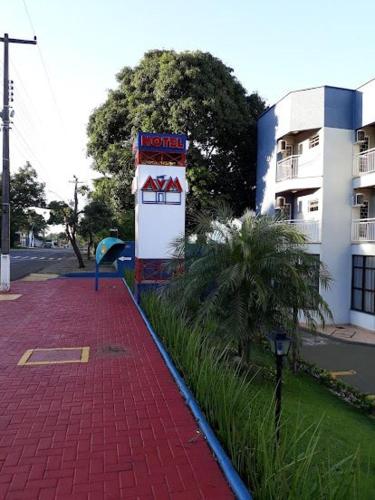 a red brick sidewalk in front of a building at Hotel AVM in Foz do Iguaçu