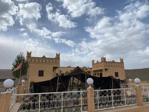 a house with a fence in front of it at Auberge & Restaurant Agoudal in Agoudal