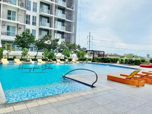 a swimming pool in front of a building at Homey-feel Studio Unit @ Lafayette Park Square Condominium in Iloilo City