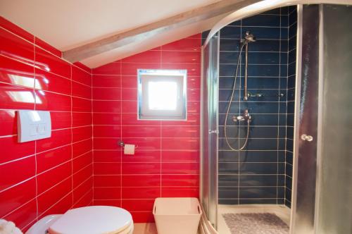 a red bathroom with a shower and a toilet at Apartment Gala Opatija in Opatija
