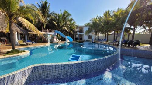 a swimming pool with a slide in a resort at Hotel Hawaian Paradise in Hawaii