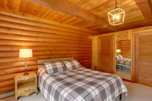 a bedroom with a bed in a log cabin at Pet-Friendly Bayfield Cabin with Game Room and Hot Tub in Vallecito