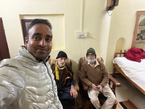 a group of three men sitting in a room at Fort View Paying Guest House in Būndi