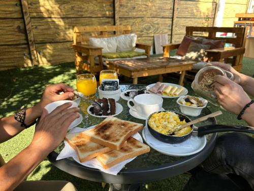 two people sitting at a table with breakfast food at Casa Di Patti B & B in Santiago