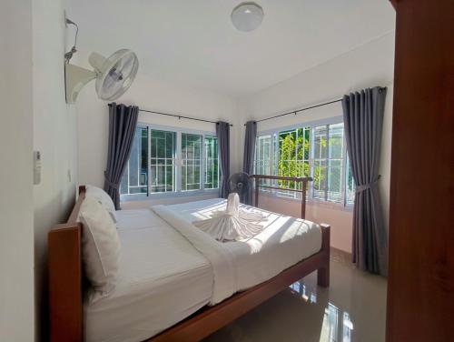 a bedroom with a bed and two large windows at SuanMalisamuiVilla G01 in Koh Samui