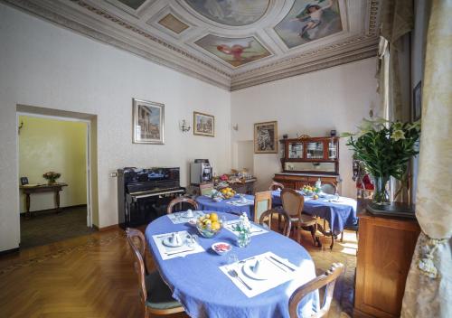 a dining room with two tables with blue table cloth at Affreschi Su Roma Luxury B&B in Rome
