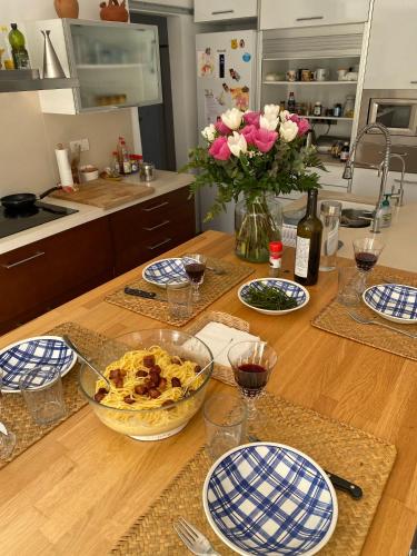 a kitchen table with a bowl of food and flowers at La Digue Beach House in San Vicente de Calders
