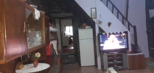 a living room with a staircase with a television at guest house in buhal in Përmet