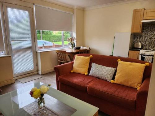 a living room with a couch and a table at * Cotswolds Get-Away Annex * in Cleeve Prior