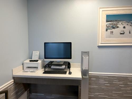 a computer on a desk with a monitor and a keyboard at Ocean East Resort Club in Ormond Beach