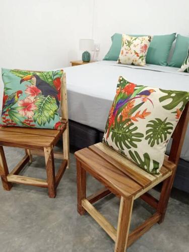 a bedroom with two chairs and a bed at Chagres River Lodge in Santa Rosa