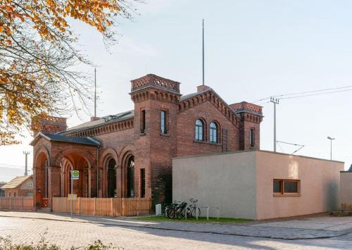 a brick building with bikes parked in front of it at A Refuge Built for a King in Halbe