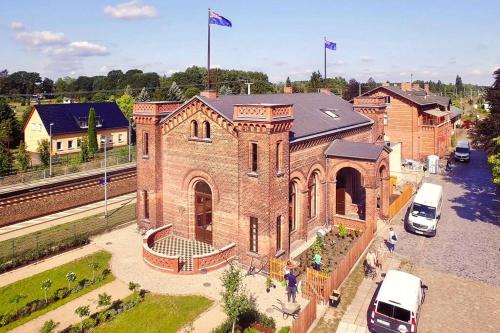 a large brick building with cars parked in front of it at A Refuge Built for a King in Halbe
