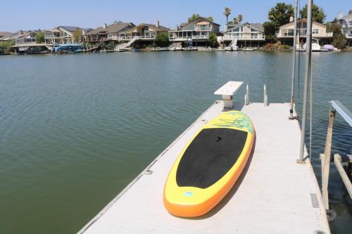 a yellow and orange boat sitting on a dock at Lakefront Gem: Private Dock in Discovery Bay