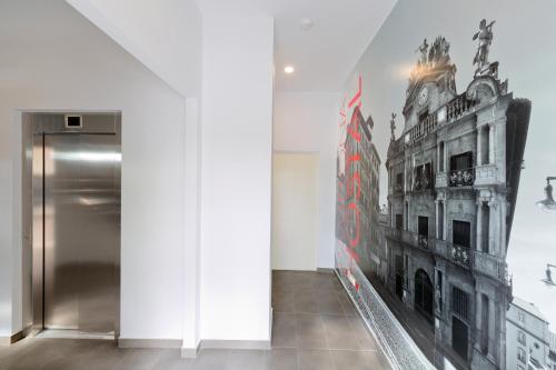 una habitación con una foto de un edificio en la pared en IRAIPE Pamplona Hostal, en Pamplona