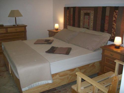 a bedroom with a bed with two towels on it at Cartoline Dall'Etna B&b in Zafferana Etnea