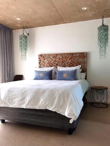 a bedroom with a large bed with blue pillows at Our Place-at-Notties Self-contained 2-Bed unit in Notties in Nottingham Road