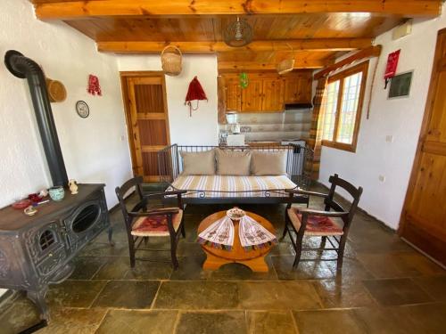 a living room with a table and a stove at Villa Kamari- Stunning Views in Kritsá