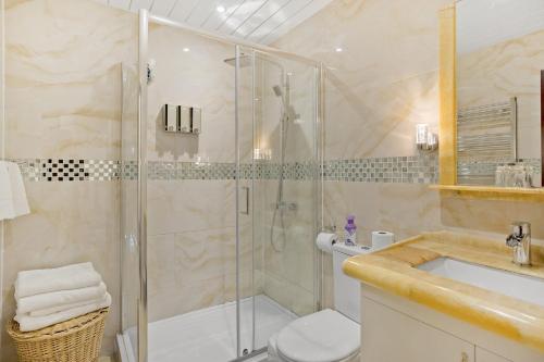 a bathroom with a shower and a toilet and a sink at Luxury Oceana Apartment, Central City Centre, Newly Refurbished in Plymouth