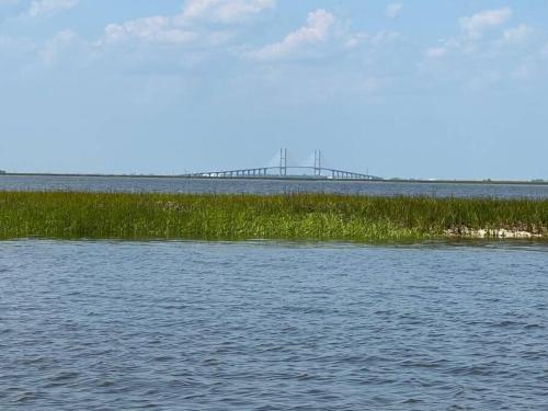 a large body of water with a bridge in the background at Papa's Escape in Brunswick