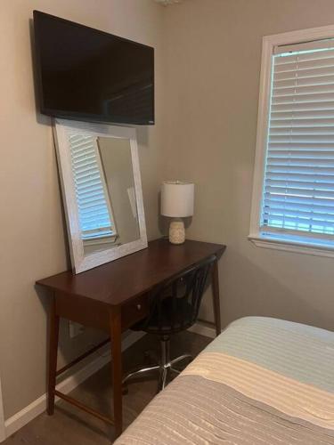 a bedroom with a desk with a mirror and a bed at Papa's Escape in Brunswick