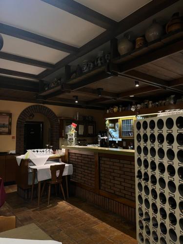 a kitchen with a table and a counter with pots and pans at Landhotel-Restaurant Wolfshof in Traben-Trarbach