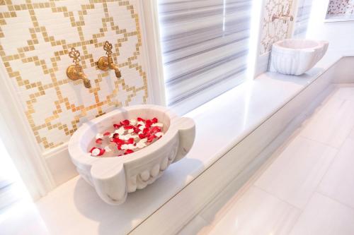a bathroom with a bath tub filled with candy canes at Kempinski Hotel San Lawrenz in San Lawrenz