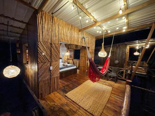 a room with a hammock in the middle of it at TORTUGA BAY Eco Hotel in El Valle