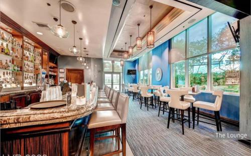 a restaurant with a bar with chairs and tables at LUXE 702 MGM Signature with Balcony in Las Vegas