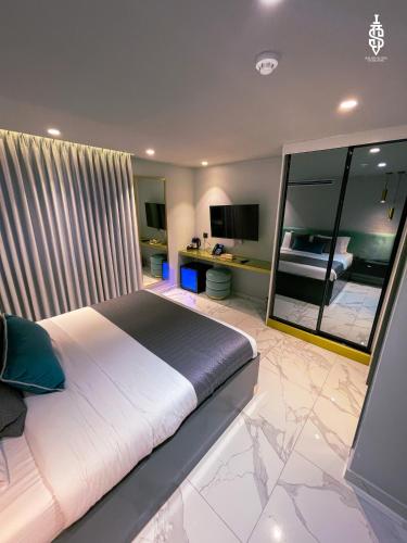 a bedroom with a large bed and a mirror at Saladin Boutique Hotel in Jerusalem