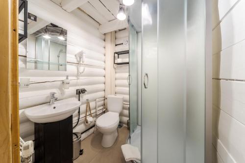 a white bathroom with a toilet and a sink at Gremi Hotel in Dragobrat