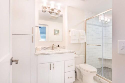 a white bathroom with a sink and a toilet at Open and Comfy home near Downtown-Folly Beach in Charleston