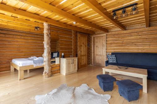 a log cabin with a bed and a table at Gremi Hotel in Dragobrat