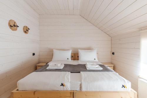 a bedroom with a bed in a white room at Gremi Hotel in Dragobrat