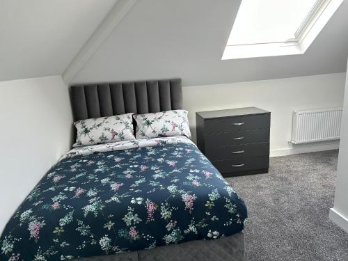 a bedroom with a bed and a dresser at Modern design residence in Dublin