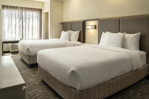 a hotel room with two beds and a window at SpringHill Suites Fort Worth University in Fort Worth