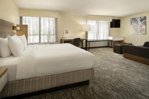 a hotel room with a bed and a desk at SpringHill Suites Fort Worth University in Fort Worth