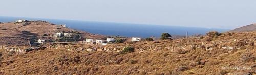a group of houses on the side of a hill at Anesis in Ioulis