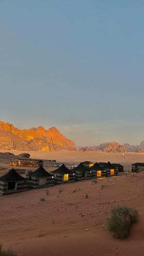 a group of huts in the middle of the desert at RUM STARDUST lUXURY CAMP in Wadi Rum